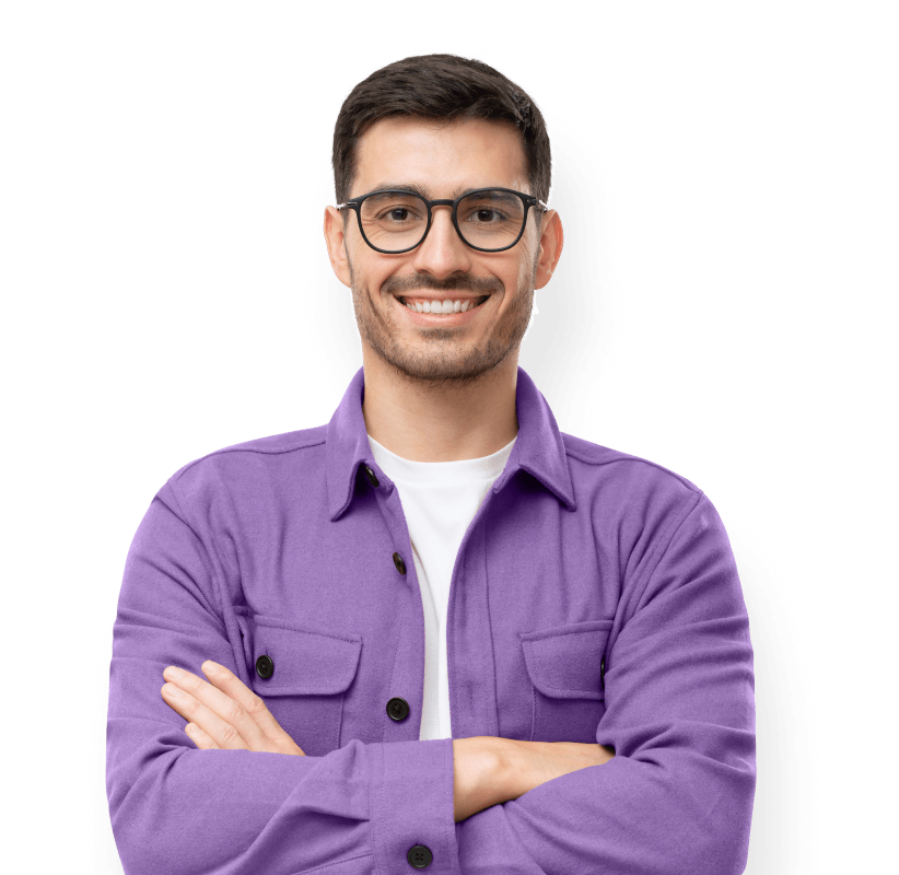 A man wearing a purple shirt and glasses, smiling confidently while standing against a neutral background.